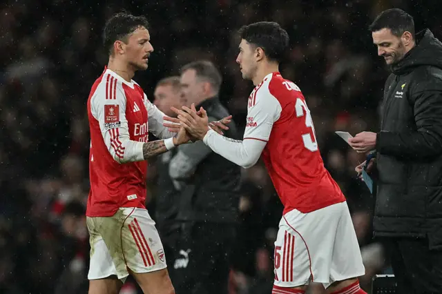 Arsenal's English defender #04 Ben White (L) is substituted out for Arsenal's Spanish defender #36 Martin Zubimendi (C) during the English FA Cup fourth round football match between Arsenal and Wigan Athletic