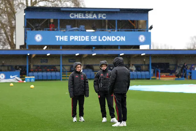 Liverpool players assess the pitch at Chelsea