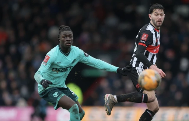 Wolverhampton Wanderers' Mateus Mane (left) and Grimsby Town's Geza David Turi in action