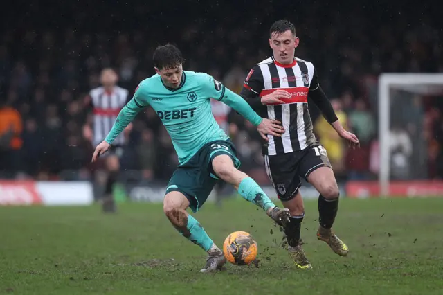 Ladislav Krejci of Wolverhampton Wanderers is put under pressure by Darragh Burns of Grimsby Town