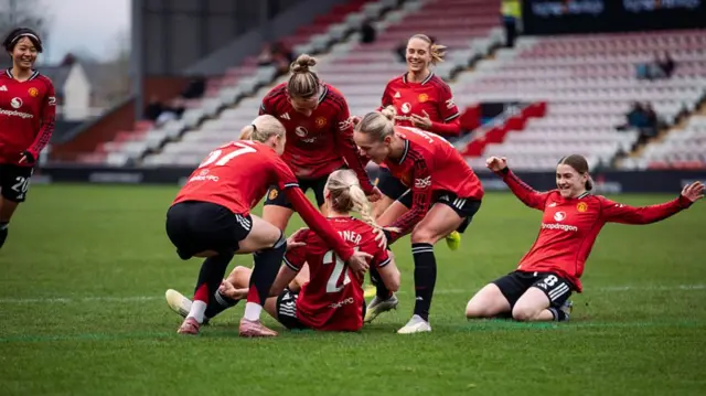 Millie Turner of Manchester United celebrates scoring her teams second goal with teammates