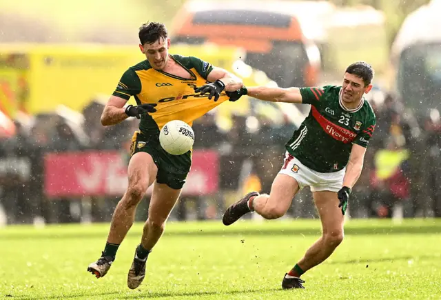 Michael Langan of Donegal in action against Conor Loftus of Mayo
