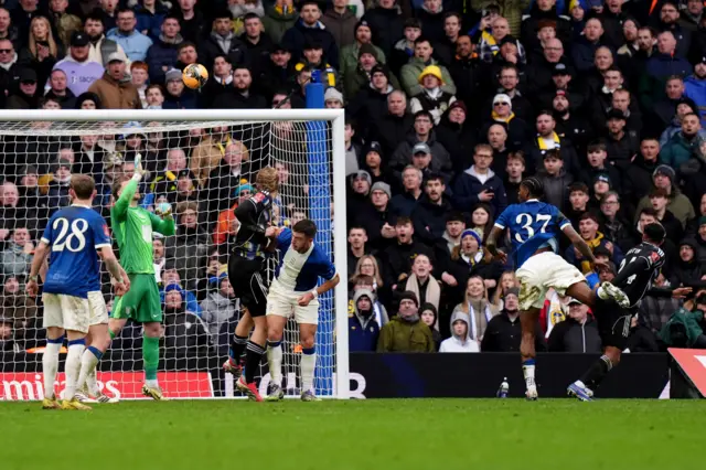 Leeds United's James Justin (right) heads over the bar