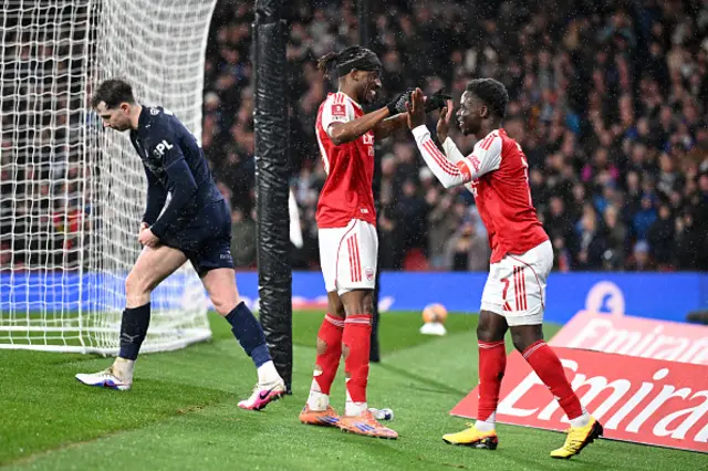 Bukayo Saka and Noni Madueke of Arsenal celebrate their team's third goal