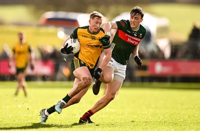 Oisín Gallen of Donegal in action against Donnacha McHugh of Mayo