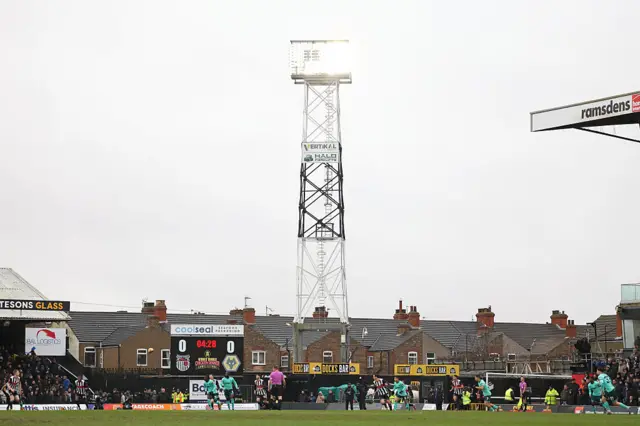 Players compete for the ball during the English FA Cup fourth round football match between Grimsby Town and Wolverhampton Wanderers at Blundell Park in Grimsby, north-east England on February 15, 2026.