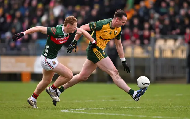 Jason McGee of Donegal in action against Jack Carney of Mayo