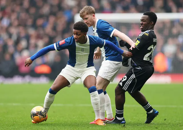Wilfried Gnonto of Leeds United is challenged by Demarai Gray and Tommy Doyle