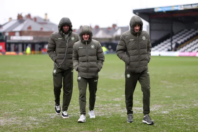 Yerson Mosquera (L), Hugo Bueno (C) and Santiago Bueno of Wolverhampton Wanderers (R) inspect the pitch