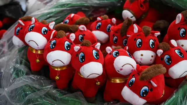 A bunch of crying horse stuffed toys sitting on a clear plastic sheet