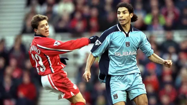 Middlesbrough's Juninho and Youssef Chippo of Coventry City challenge for a ball in a Premier League game in February 2000