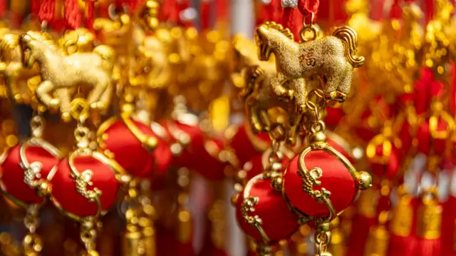A cluster of gold and red-coloured Year of the Horse ornaments