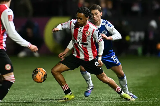 Brentford's English midfielder #45 Romelle Donovan (L) vies with Macclesfield's English defender #15 Luis Lacey (R) during the English FA Cup fourth round football match between Macclesfield Town and Brentford at Leasing.com Stadium, Moss Rose in Macclesfield, northern England on February 16, 2026.