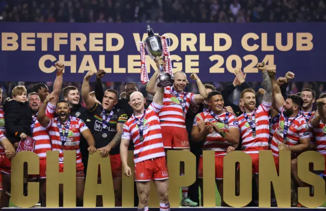 Liam Farrell of Wigan Warriors lifts the Betfred World Club Challenge trophy after the team's victory in the Betfred World Club Challenge match between Wigan Warriors and Penrith Panthers at DW Stadium on 24 February 2024, in Wigan