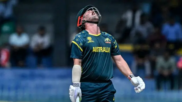 Australia's Travis Head reacts after being bowled by Zimbabwe's Brad Evans