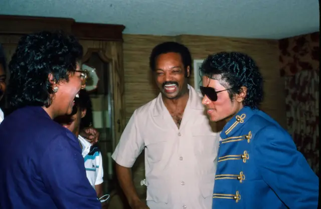 Jesse Jackson laughs during a meeting with Michael Jackson in 1984