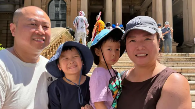 A family of four - a man, a woman and two young boys