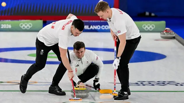 Britain's Hammy Mcmillan, Britain's Bruce Mouat and Britain's Bobby Lammie compete in the curling men's round robin between Canada and Britain during the Milano Cortina 2026 Winter Olympic Games