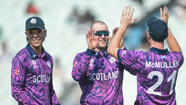 Michael Leask celebrates after taking a wicket against Italy