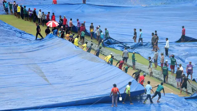 The covers are moved at the Pellekele Cricket Ground in Kandy