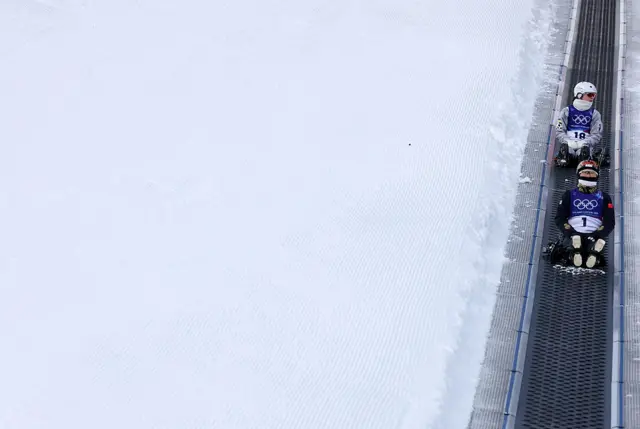 Nelli Popovych of Team Ukraine and Mengtao Xu on conveyor belt to top of slope