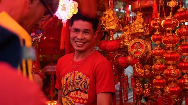 Man in red surrounded by red lucky charms