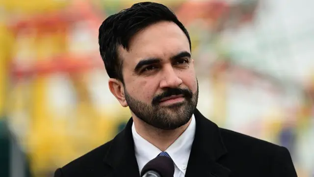 Mamdani speaking at an event.