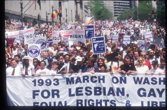 Jesse Jackson leads a march with other participants carrying a banner during the Gay Rights March April 25, 1993 in Washington.