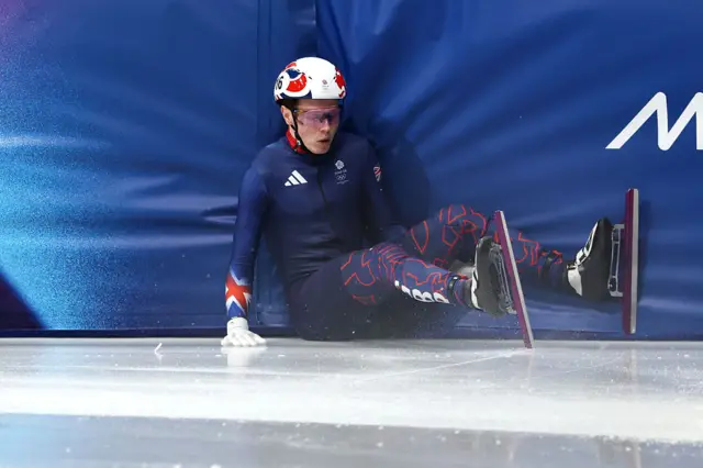 Niall Treacy of Team Great Britain crashes out of heat 8 of the Short Track Speed Skating Men's 500m