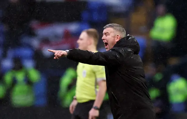 Steven Schumacher points and shouts to his players