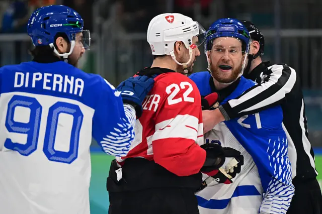 Switzerland's #22 Nino Niederreiter reacts next to Italy's #21 Daniel Glira and Italy's #90 Dylan Di Perna during the men's qualification play-off