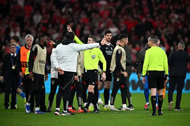 Referee Francois Letexier shows a red card to a member of Benfica staff