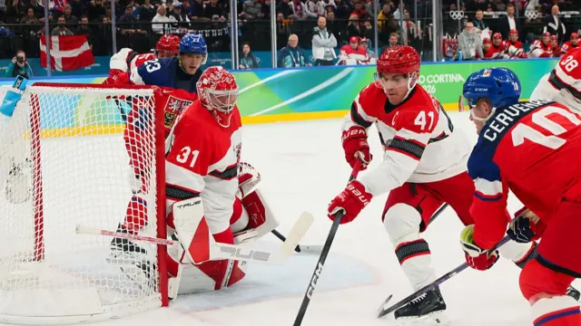 : Jesper Jensen Aabo #41 of Team Denmark controls the puck against Roman Cervenka #10 of Team Czechia in the first period during the Men's Qualification Playoff match between Czechia and Denmark