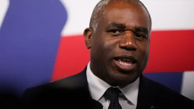 Close up of David Lammy wearing a black suit