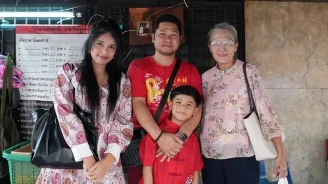A family of four, including one boy, posing for a photo