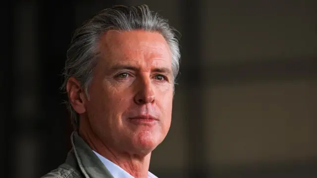 California Governor Gavin Newsom looks on at the camera