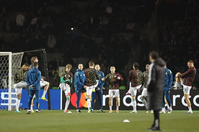Newcastle United's players warm up prior to the UEFA Champions League knockout phase play-off first leg