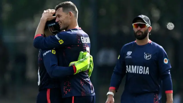 Namibia's captain Gerhard Erasmus (C) celebrates with teammates after taking the wicket of Pakistan's Khawaja Nafay