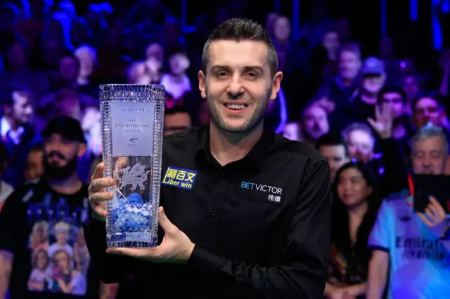 Mark Selby of England poses with the champions trophy after winning the Final match against Stephen Maguire of Scotland