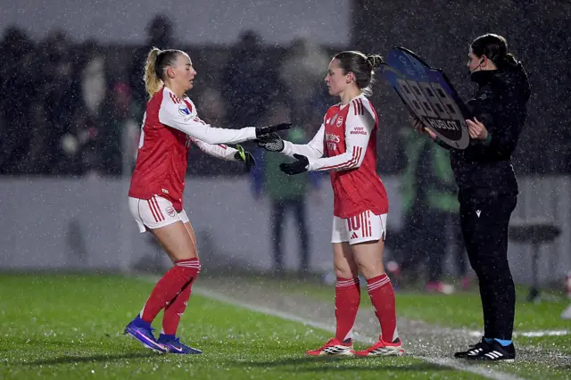 Kelly hands Little the armband as she prepares to come on