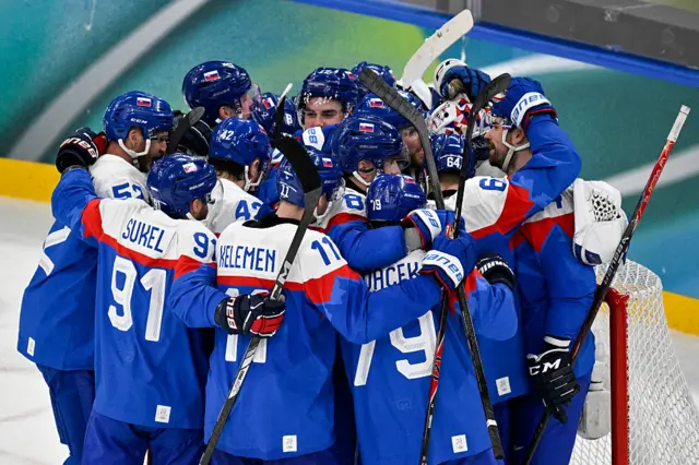 Slovakia's players celebrate after winning the men's play-off quarter-final ice hockey match between Slovakia and Germany
