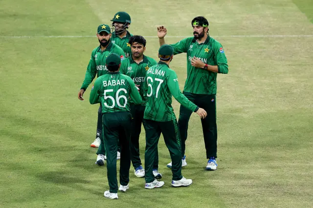 Usman Tariq of Pakistan is congratulated by Shadab Khan after taking the wicket of Willem Myburgh