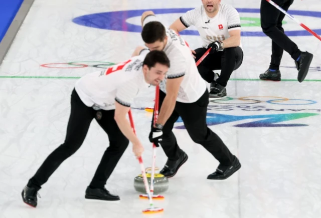 Sven Michel of Switzerland gibes instructions in the Men's Curling semi final match between Great Britain