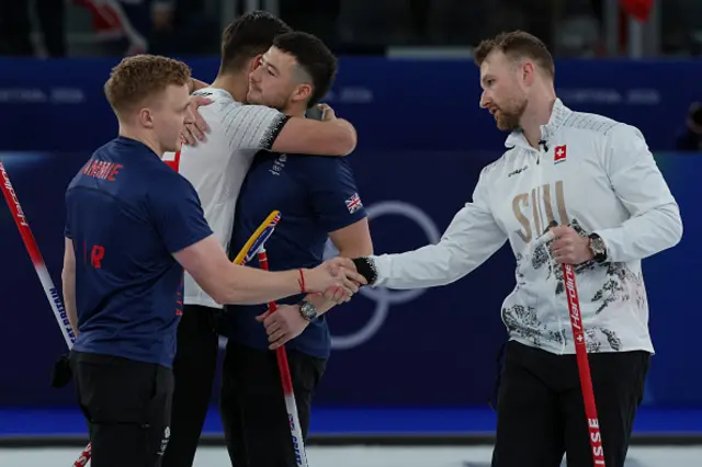 Britain's Hammy McMillan and Switzerland's Yannick Schwaller greet each other after the curling men's semi-final