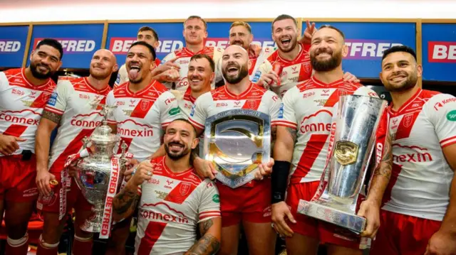 Hull KR with each trophy from their 2025 treble