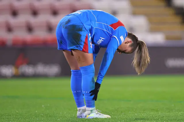 Carmen Menayo adjusts her socks after getting booked