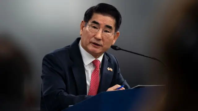 Kim Yong-hyun speaking at a podium