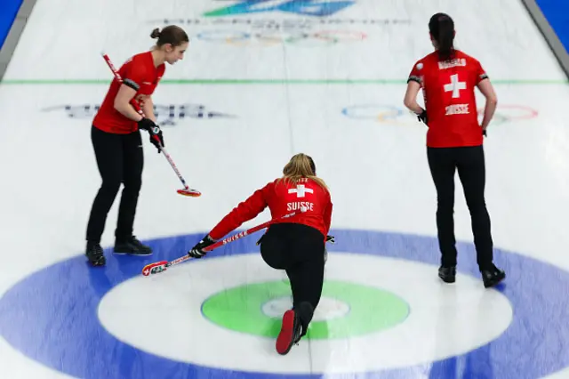 Switzerland's team competes in the curling women's round robin between Switzerland and USA