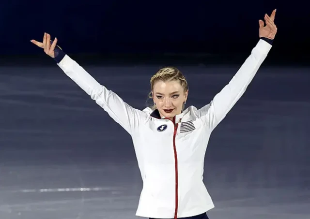 Amber Glenn gestures towards the crowd