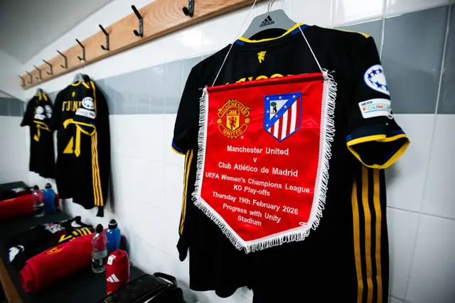 United shirts hang in the home dressing room